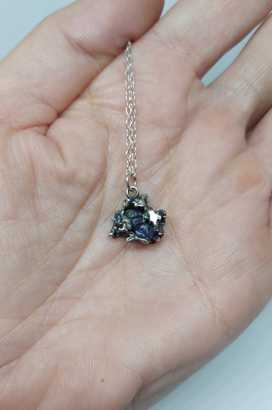 Handmade sterling silver pendant created through fire, salt, and intuition.